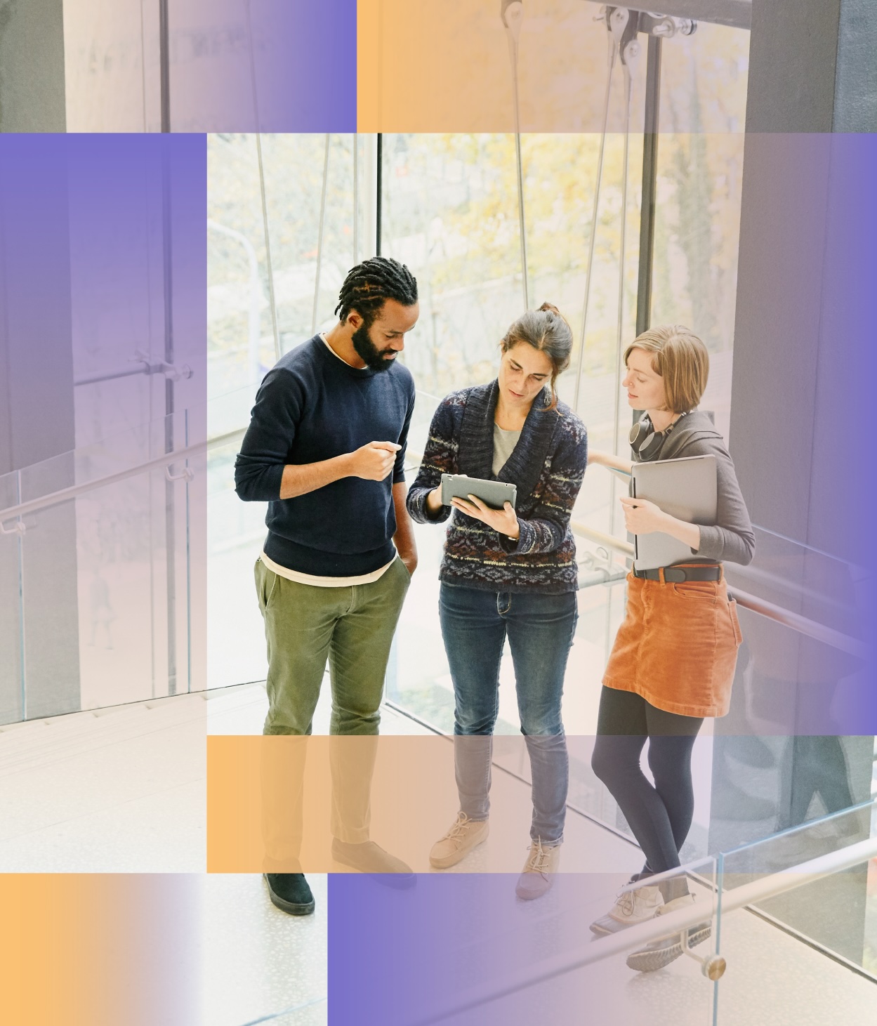 Team members discuss a work project on an office staircase