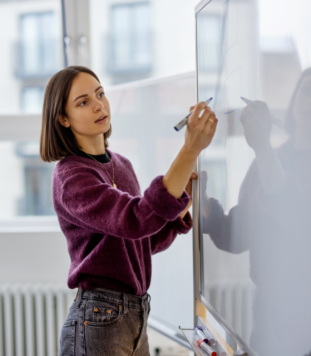 Woman writing on a whiteboard 